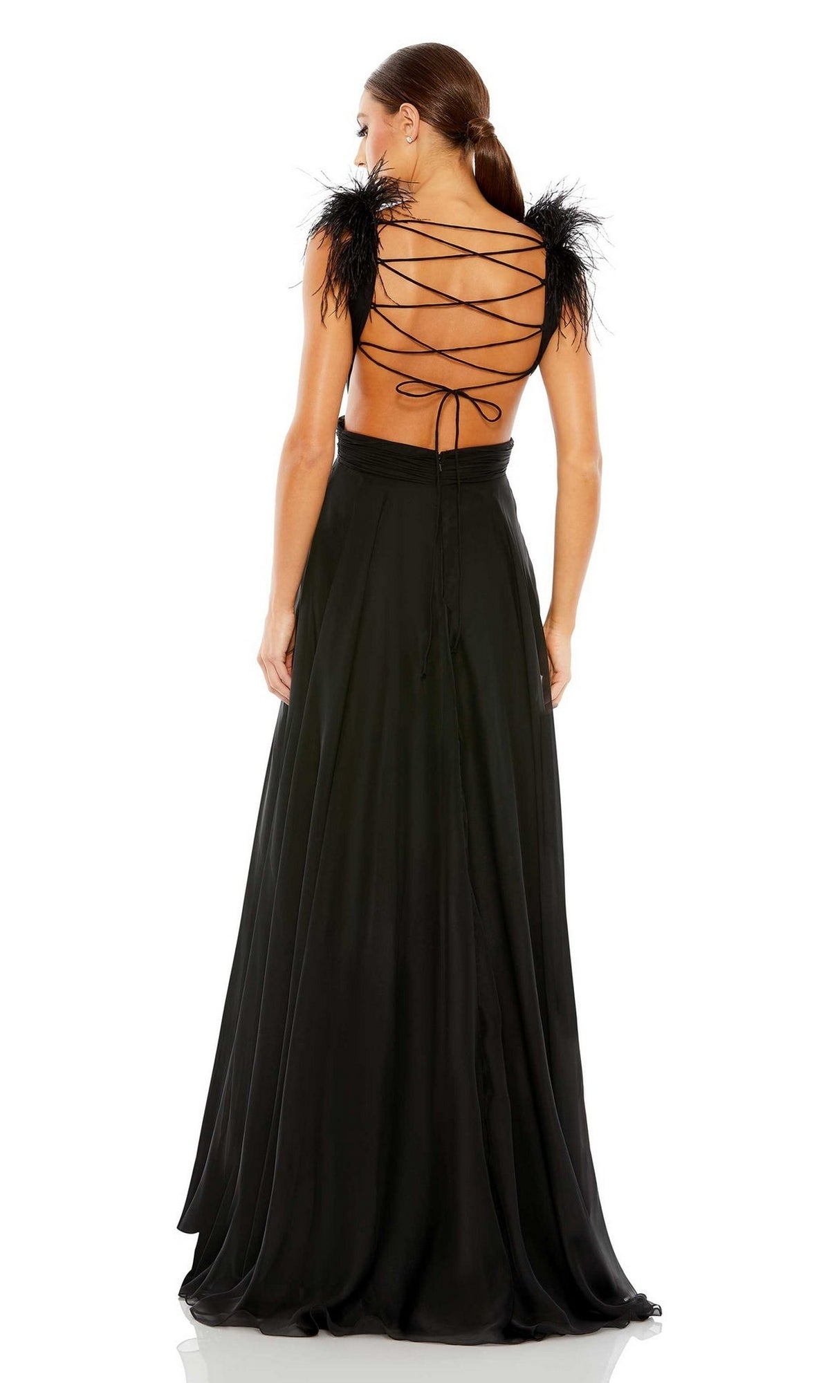Woman wearing the Mac Duggal 68113 Feather-Trim Long Formal Dress, featuring a strappy open back, lace-up detail, feathered shoulder accents, and a flowing floor-length skirt as she stands with her back to the camera.